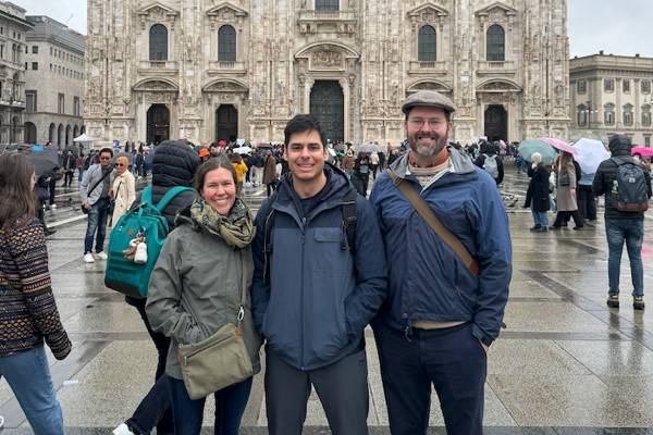 Three Humanities faculty standing in front of the Milan Cathedral
